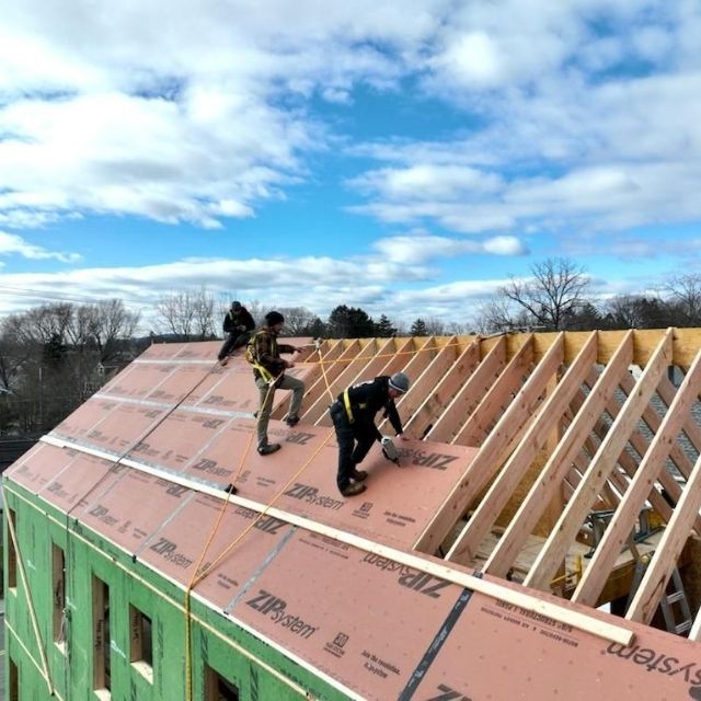 Roofing Replacement in Bridgewater, MA crew installing new shingles.