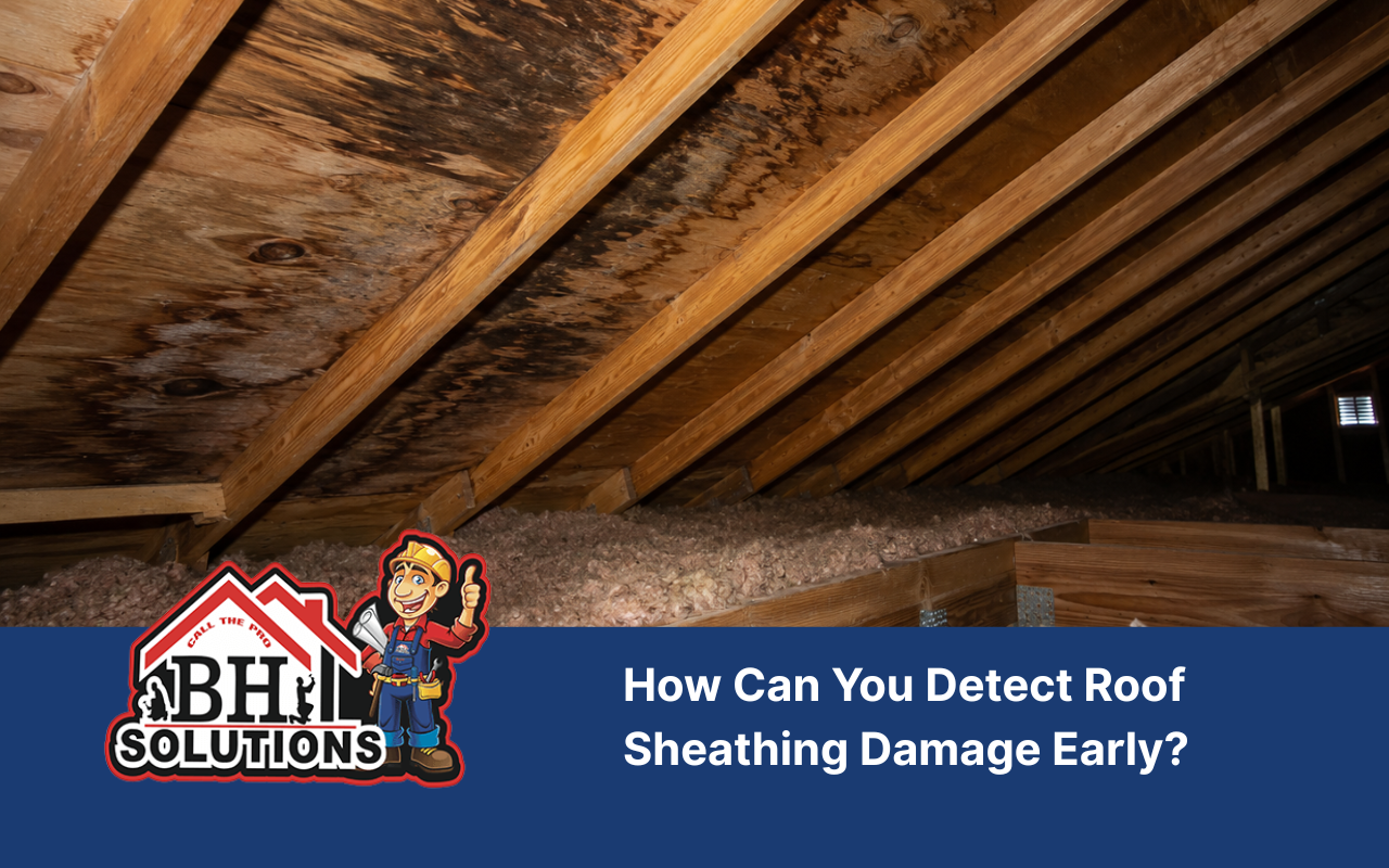 Roof sheathing damage visible as dark moisture stains inside an attic