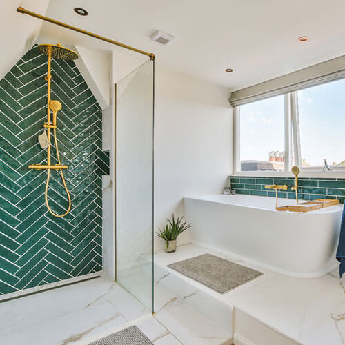 Bathroom shower with a low entry, built-in bench, and grab bar.